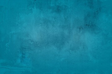 Old blue wall in spots, cracks, stains. Painted concrete wall in abstract grunge style loft. Vintage wall background texture for backgrounds, portraits, posters.