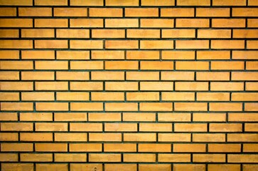 Weathered stained old yellow brick wall background