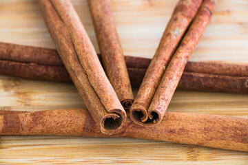 Close up of pile of cinnamon sticks isolated on wooden background