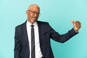 Business senior man isolated on blue background proud and self-satisfied