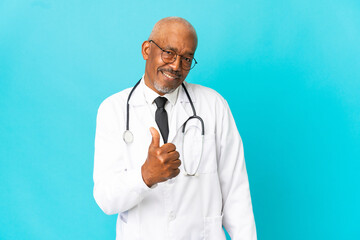 Senior doctor man isolated on blue background proud and self-satisfied