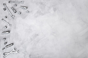 Fototapeta premium Construction background of gray color with hand tools for repair located on it, top view. Equipment on concrete floor, copy space.