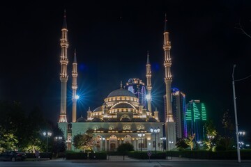 Fototapeta na wymiar Russia, Chechnya, the Chechen Republic, the city of Grozny. Night view of the mosque the heart of Chechnya against the backdrop of skyscrapers Grozny city