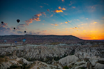 Cappadocia, Turkey - September 1, 2021 - Cappadocia Panoramic - Hot air balloon flying in early morning over rock landscape at Cappadocia Turkey