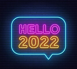 Hello 2022 neon sign on a brick wall background.