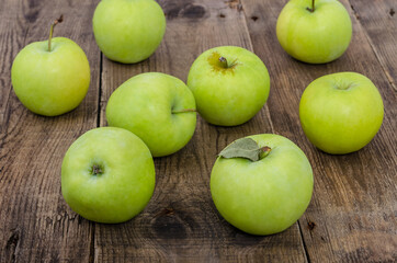 Green apples on the wooden table