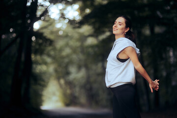 Fototapeta na wymiar Sporty Woman Stretching Her Arms Before Jogging 