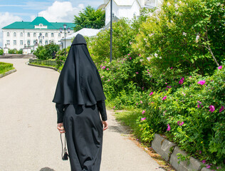 Diveevo, Russia. June 12, 2021. A nun goes to an Orthodox church. Christian temple.