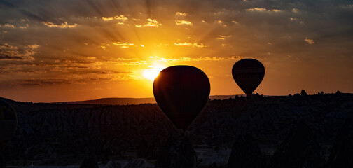 Cappadocia, Turkey - September 1, 2021 - Cappadocia Panoramic - Hot air balloon flying in early...