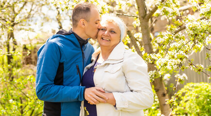 Man hugging his mother in the garden