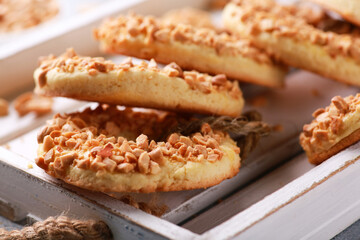 Bakery products. Homemade cakes. Cookies with nuts, shortbread cookies rings. Cookies with peanuts on a white wooden board on a light gray background. Background image, copy space