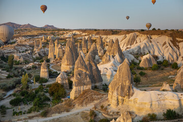 Cappadocia, Turkey - September 1, 2021 - Cappadocia Panoramic - Hot air balloon flying in early morning over rock landscape at Cappadocia Turkey