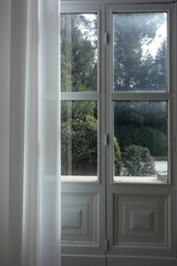   
interior italian style:  calm room, exit from house to the garden, white wooden doors with glass, classic cozy curtains