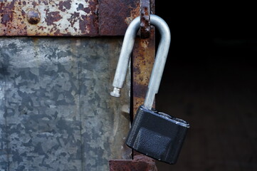 an open lock on an old rusty door