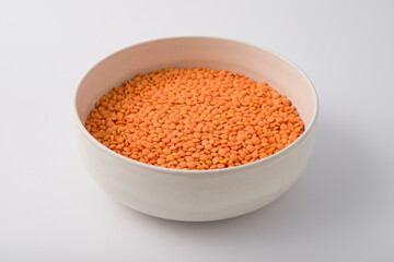 Red or Pink Lentils on round large white plate. isolated on white