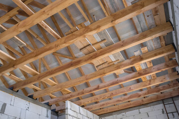 New construction of the house. Construction with wooden roof, pillar and frame beams. Roofing structures