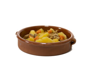 Potato stew with beef, a food widely consumed in Spain. Isolated on white. Selective focus, copy space