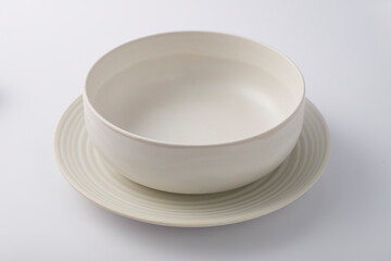 Empty pot and plate on white background