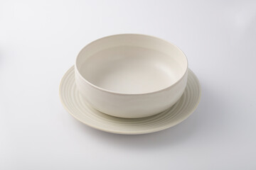 Empty pot and plate on white background