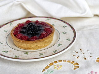 a delicious tart with berries and custard