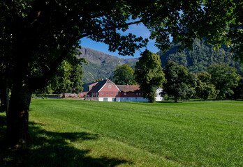 Casa noruega en fiordo con montaña