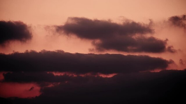 Scenic big clouds moving in the red sky at sunset. Timelapse. 