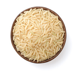 uncooked brown rice in the wooden bowl, isolated on the white background, top view