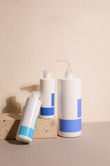 Eco friendly Bottle and tube with natural skincare cosmetics, creams or oils on light background. Plant-based beauty products