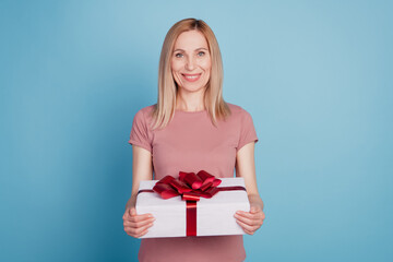 Photo of young attractive woman happy positive smile hold present box celebration isolated blue color background