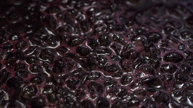 Dark red black currants are boiled in sugar syrup, turning into a healthy jam.