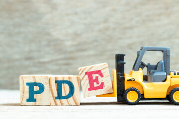 Toy forklift hold letter block e to complete word PDE (abbreviation of permitted daily exposure,...