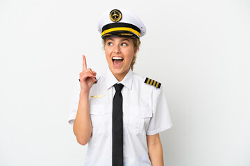 Airplane blonde woman pilot isolated on white background thinking an idea pointing the finger up