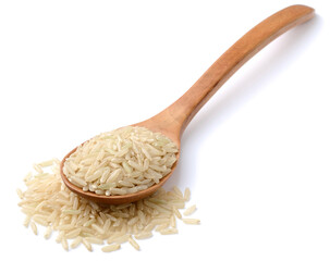 raw long brown rice in the wooden spoon, isolated on the white background