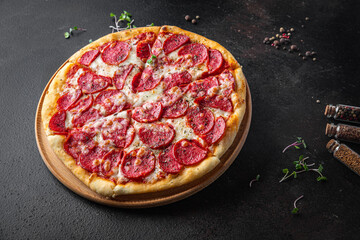 Pizza salami or pepperoni sausage, cheese, tomato sauce, dough fresh portion ready to eat meal snack on the table copy space food background rustic. top view