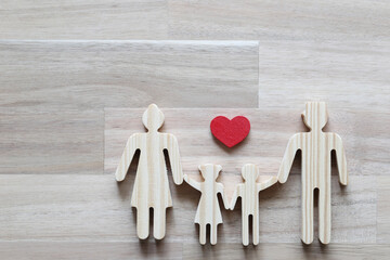 Happy family with red heart on wooder background,Health care and insurance concept