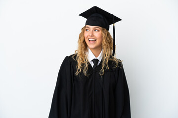Young university graduate isolated on white background looking to the side and smiling