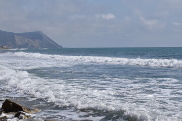 View of the Black Sea, beach and mountains. The resort town of Anapa. Russia. Photo taken in spring.