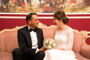 Wedding in moscow. 40 years. Husband and wife are sitting on a luxurious couch