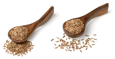 dried caraway seeds in the wooden spoon, isolated on white