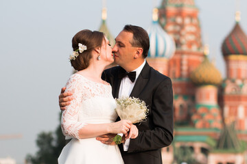 Kiss of 40 year old bride and groom on Red Square in Moscow
