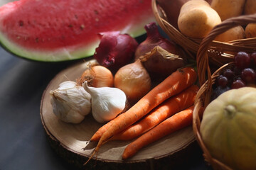 Various seasonal fruit and vegetable on dark background. Selective focus.