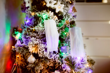 False-use mask adorns the New Year tree concept quarantine and coronavirus,