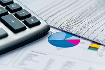 Financial charts and graphs on table with calculator. Stock market or trading charts. Finance markets concept	