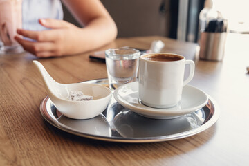 Traditional Turkish coffee with cold water and Turkish delight in cafe. Selective focus