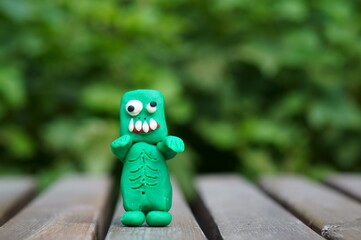 Figure of a funny zombie made of plasticine close-up. Halloween theme.