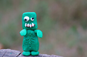 Figure of a funny zombie made of plasticine close-up. Halloween theme.