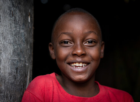 African Black Boy Portrait Standing Near His Poor House Alone