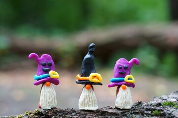 Figurines of three fairy-tale dwarfs made of plasticine. The concept of Halloween.