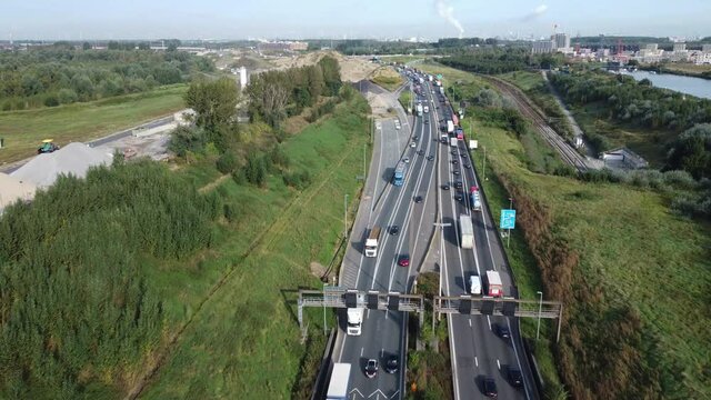 Drone shot of vehicles driving on the highway across the Kennedy tunnel in Antwerp