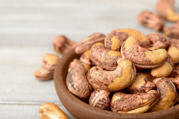 roasted cashew nuts in the wooden bowl on the table